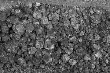 Closeup of dark rock background. Black rough stone texture and background for design