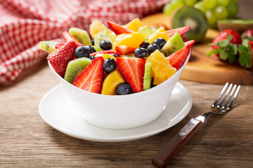 Fototapeta na wymiar bowl of fruit salad on a wooden table