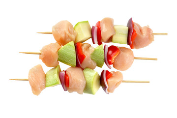 chicken skewers with vegetables on a white background