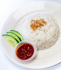 Asian Food - White Rice, Sambal and Cucumber on a plate. Isolated on white