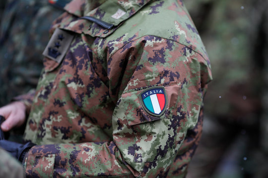 Details with the uniform and the flag on it of an Italian soldier taking part at the Romanian National Day military parade.