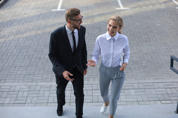 Business man and woman walking in the office center.