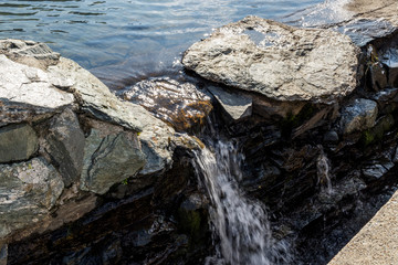 Beautiful small mountain waterfall on a sunny day