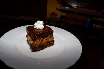 Chocolate cake with a touch of whipped cream on top