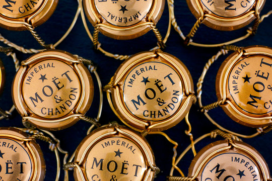 Tambov, Russian Federation - February 14, 2020 A lot of Moet & Chandon Champagne muselets with caps on black background.