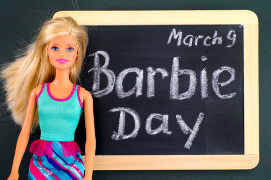 Tambov, Russian Federation - February 24, 2020 Blond Barbie Doll And Blackboard With Words Barbie Day March 9th. Studio Shot.