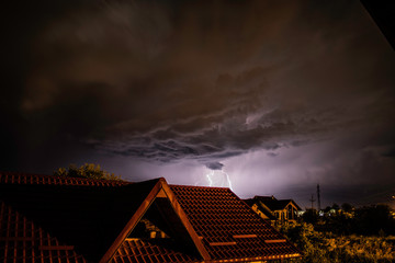 Fototapeta na wymiar Lightning storm over a residential area