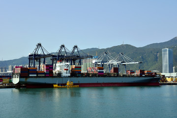 View of the sea port with container terminal in Yantian, China. Ship berthed under gantry cranes...
