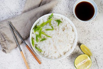 A bowl of cooked rice with chopsticks. Classic Japanese side dish.Top view