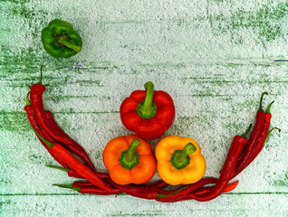 Colorful chilli peppers and paprika on the table