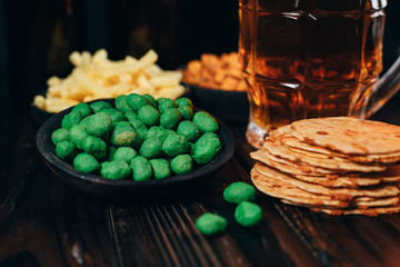 Beer and salty snacks. table with two mugs of craft lager and crunchy appetizers. Oktoberfest food, pub concept