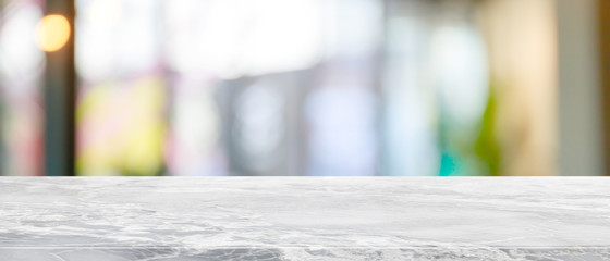 Empty white marble stone table top and blur glass window interior restaurant banner mock up abstract background - can used for display or montage your products.