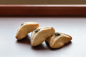 ozney haman (Haman Ear) Triangular pastry made of crispy dough stuffed. Traditional Jewish food for Purim. Located on a wooden surface