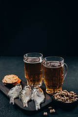 beer and snacks. delicious lager drink, dried fish and salted nuts. friday party atmosphere, craft brewery, bar table. restaurant, pub, food concept