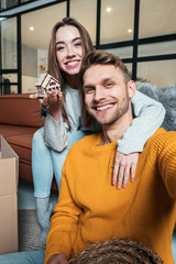 Young adult couple together move in new apartment