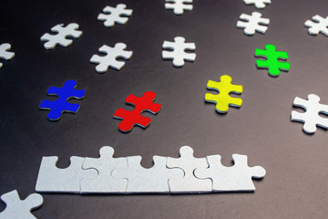 White and color puzzles on a black background