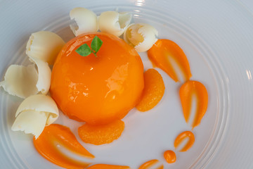  orange dome cake on white plate