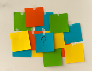 memo sheets on the wall with question mark