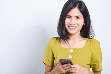 young woman standing smile holding using mobile smart phone