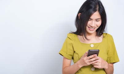 young woman standing smile holding using mobile smart phone
