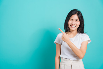 Portrait Asian beautiful young woman standing pointing finger up