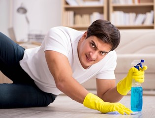 Man husband cleaning the house helping wife