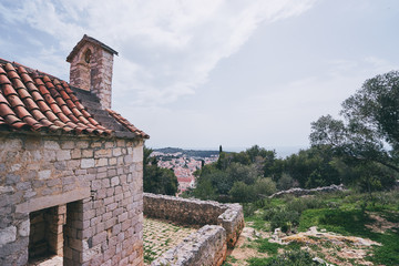 Ancient small catholic chapel made from stones with tiled roof.