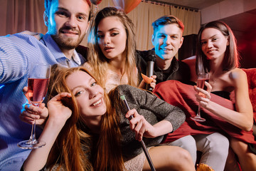 happy cheerful adults, women and men spending day-off in karaoke bar, young ladies and guys wearing...