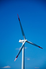 Wind turbine on blue sky clouds green energy concept renewable energy generator