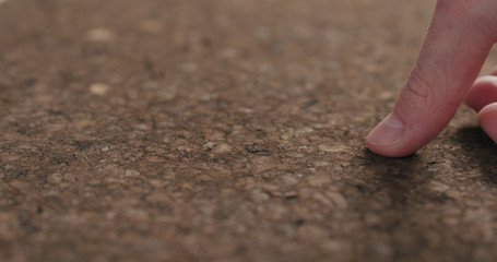 man hands touch dark cork surface