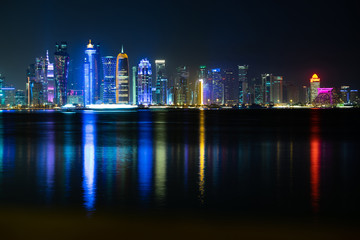 Fototapeta premium Vibrant Skyline of Doha at Night as seen from the opposite side of the capital city bay at night