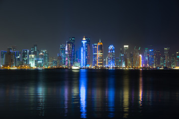 Fototapeta premium Vibrant Skyline of Doha at Night as seen from the opposite side of the capital city bay at night