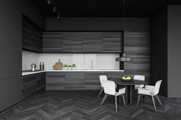 Modern dark kitchen interior with round table