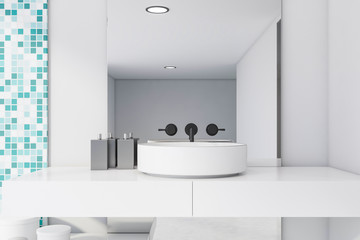 Obraz na płótnie Canvas Bathroom sink in white and blue tile room