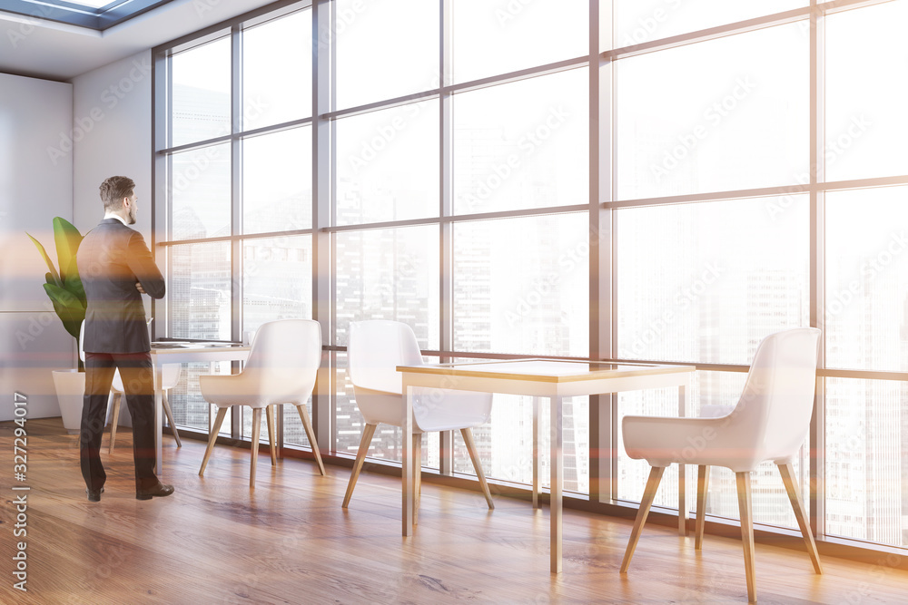 Wall mural Man in panoramic white restaurant interior