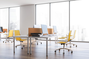 White open space office with yellow chairs