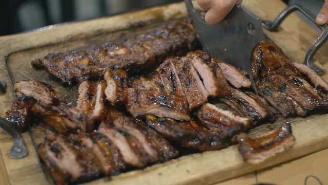 waiter cuts fried pork ribs