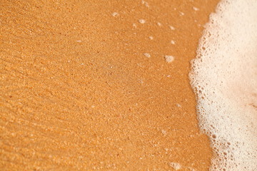 foam on sandy tropical ocean beach