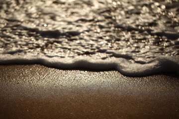 Fototapeta na wymiar foam on sandy tropical ocean beach