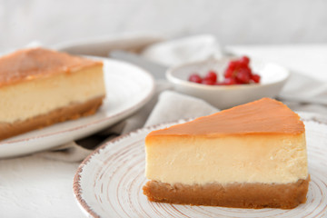 Slice of sweet caramel cheesecake on plate