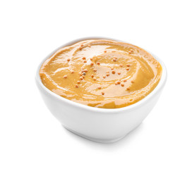 Bowl of tasty honey mustard sauce on white background