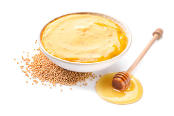 Bowl of tasty honey mustard sauce on white background