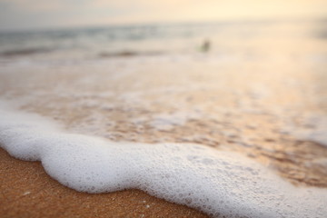 foam on sandy tropical ocean beach