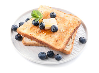 Tasty toasted bread with honey, butter and berries on white background