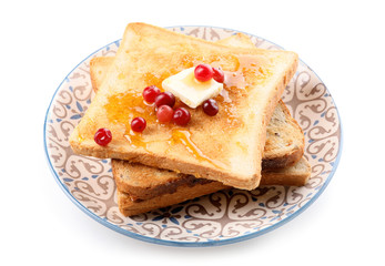 Tasty toasted bread with honey, butter and berries on white background