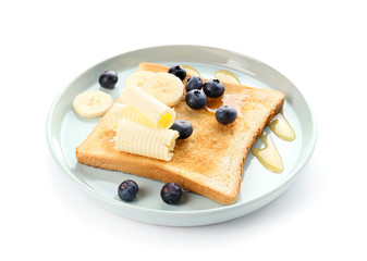 Tasty toasted bread with honey, butter and fruits on white background