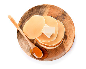 Tasty pancakes with honey and butter on white background
