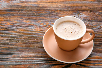 Cup of hot coffee on wooden table