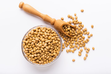 Soya beans in glass bowl and wooden spoon