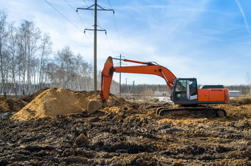 excavator digging a hole, landscape